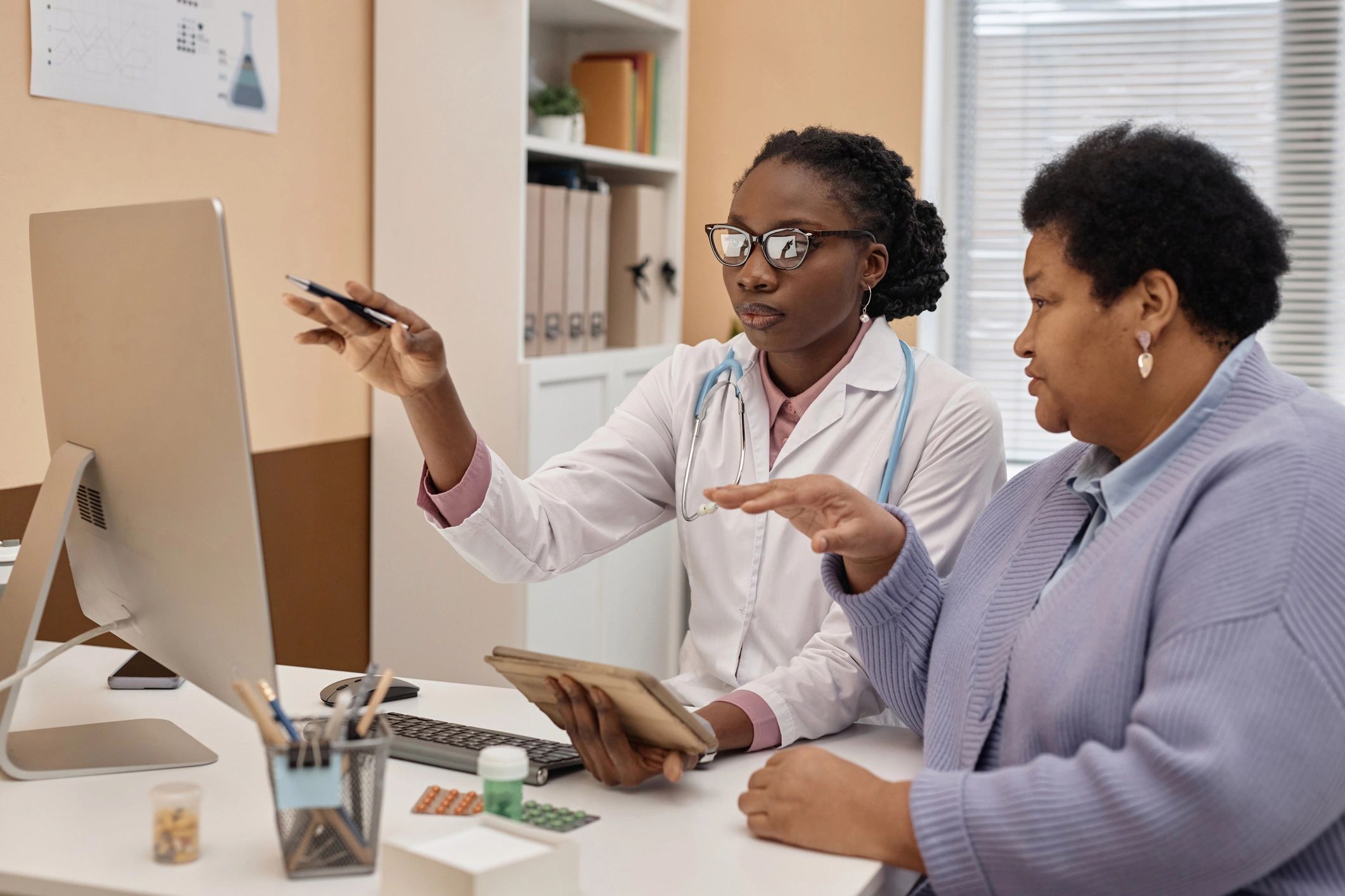 Caribbean healthcare professional using a computer for patient consultation