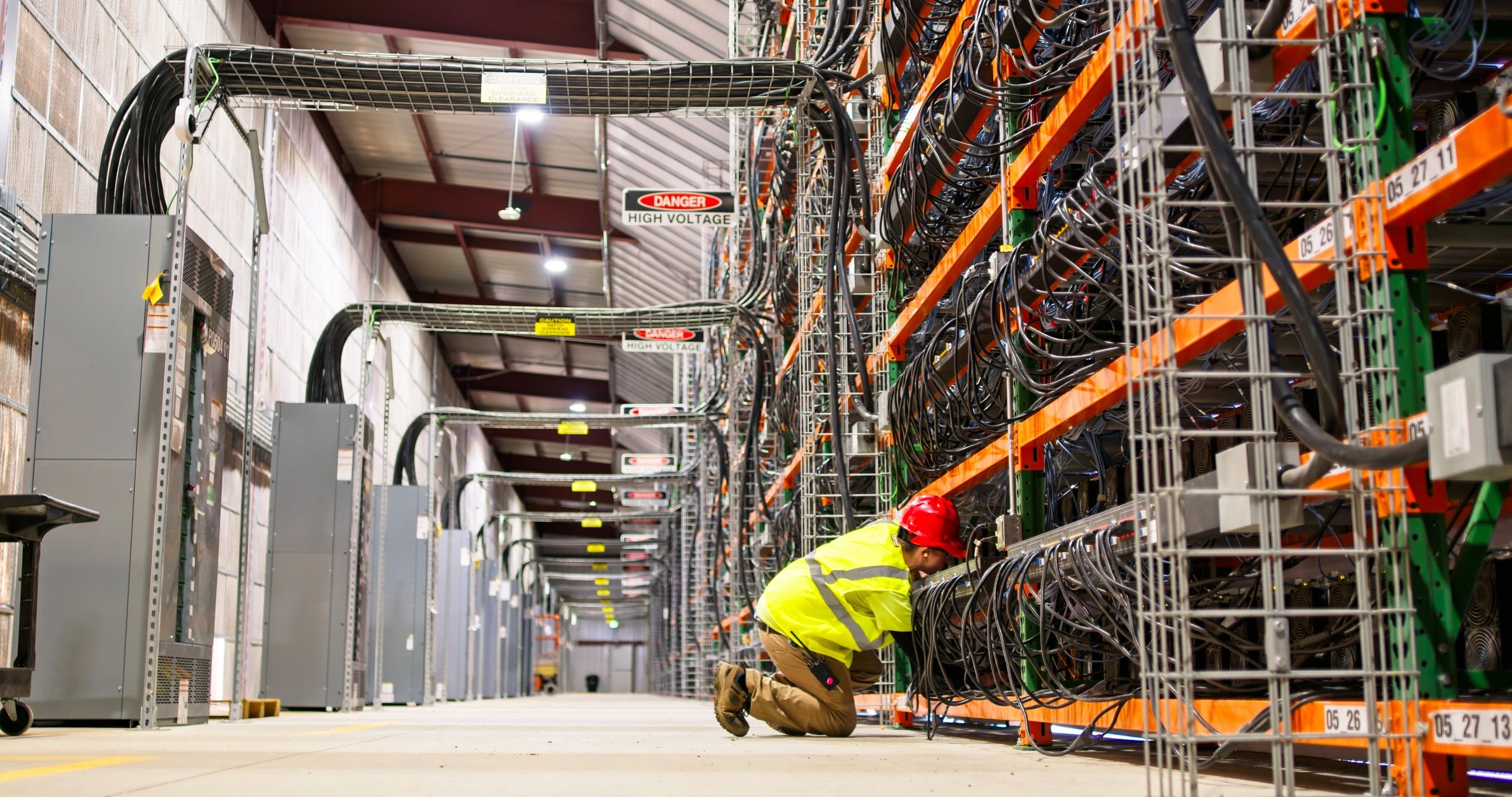 Technician working in a large data centre
