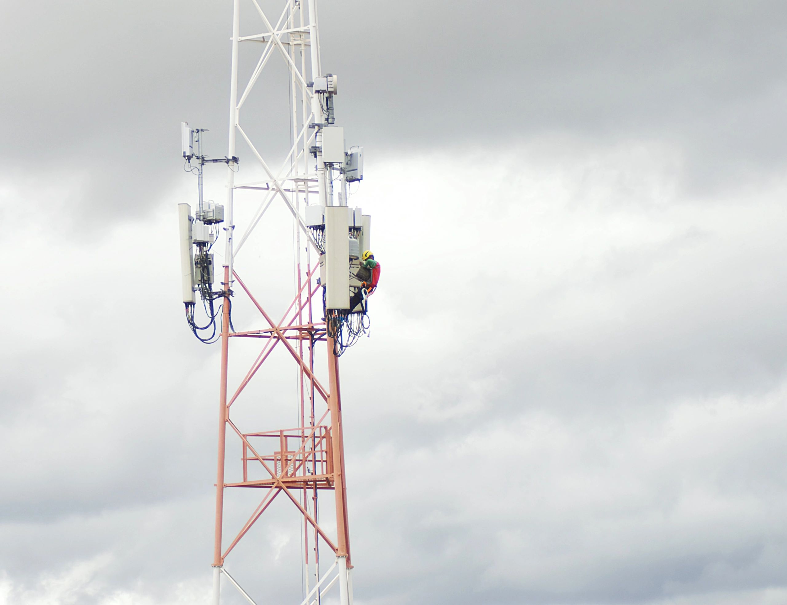 Telecommunications technician working on a transmission tower