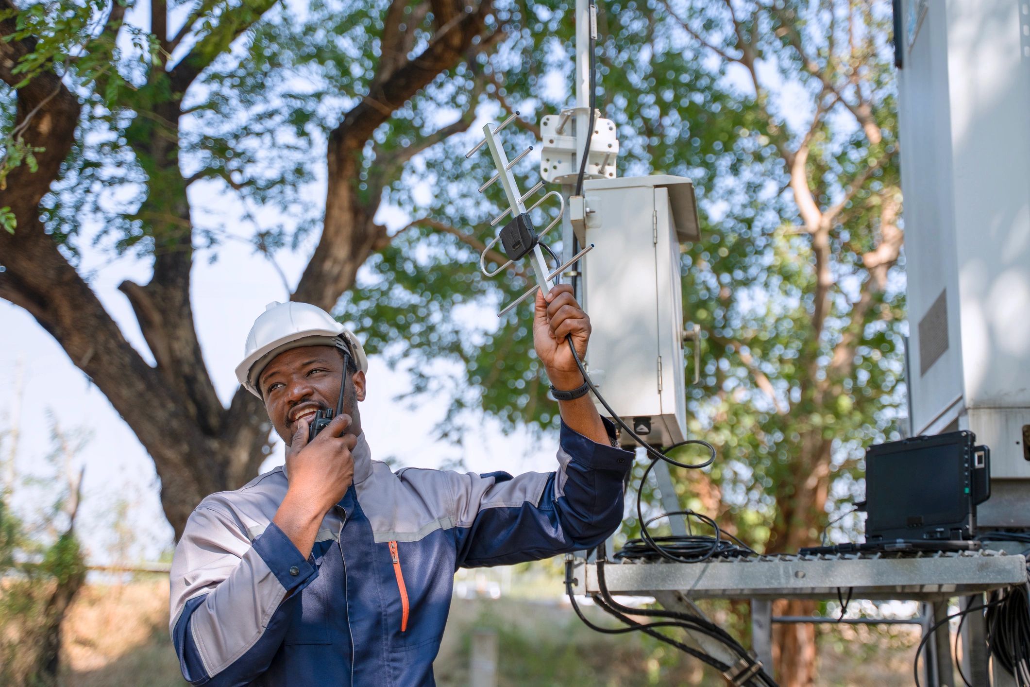 Network engineer inspecting wireless communications equipment